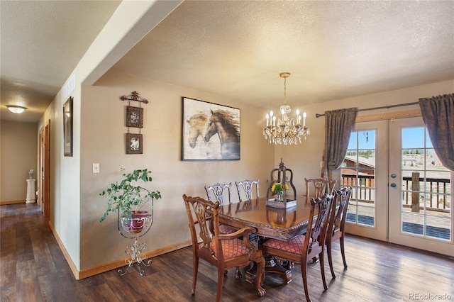 dining room with a textured ceiling, dark hardwood / wood-style flooring, french doors, and an inviting chandelier