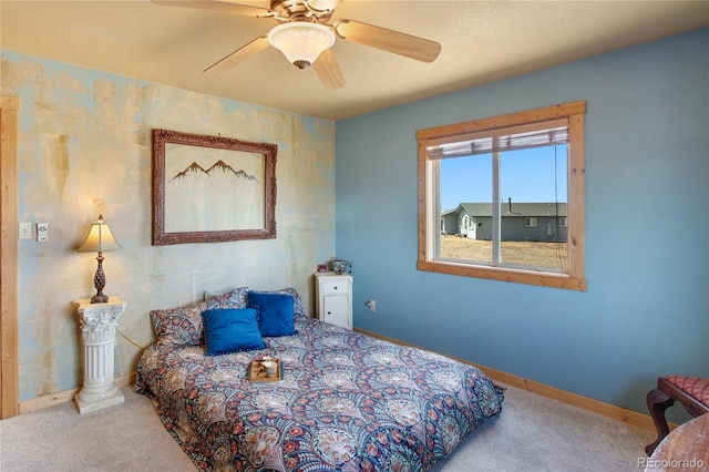 bedroom featuring ceiling fan and carpet