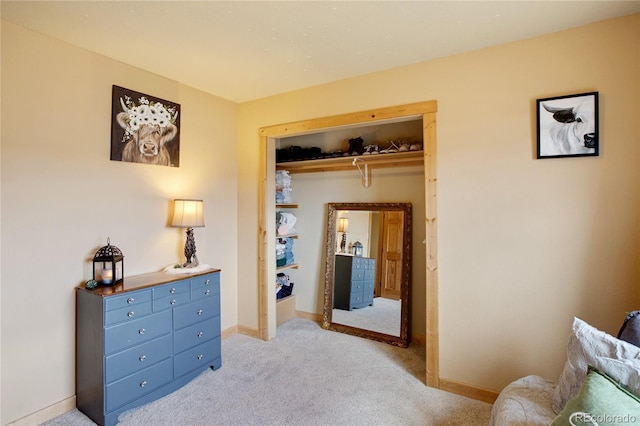 bedroom with light carpet and a closet