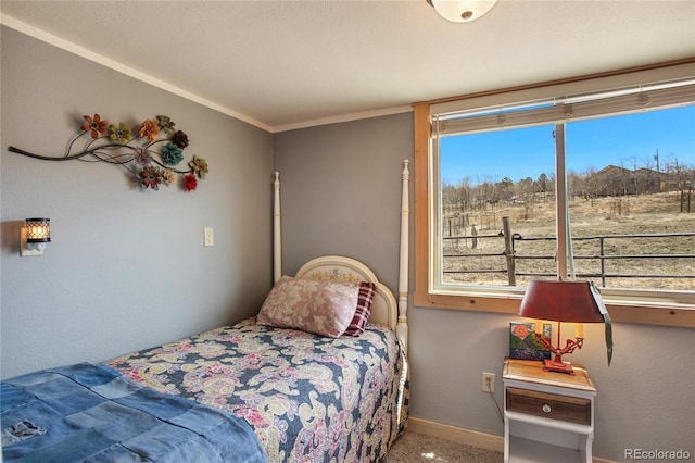 carpeted bedroom with ornamental molding