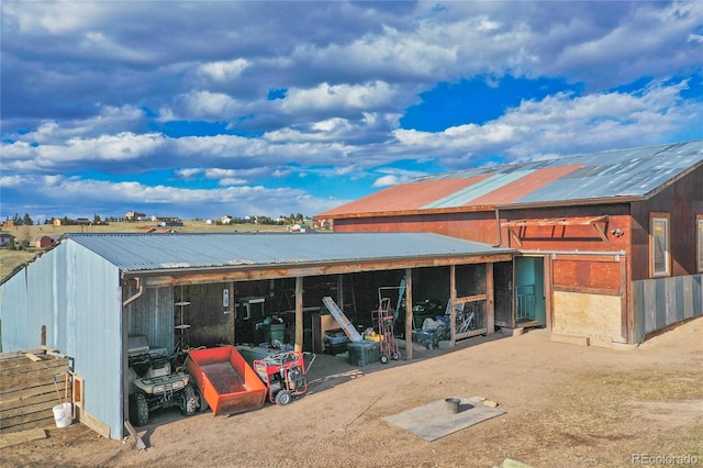 rear view of house featuring an outdoor structure