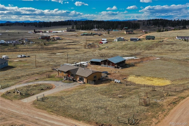 birds eye view of property featuring a mountain view and a rural view