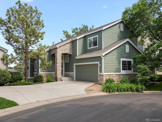 7400 W Grant Ranch Blvd Unit 19, Littleton, CO 80123 - view of front of home with stone siding, an attached garage, and driveway