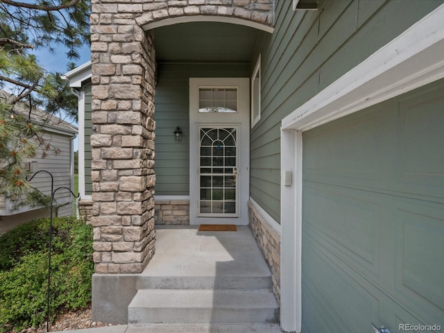 7400 W Grant Ranch Blvd Unit 19, Littleton, CO 80123 - view of exterior entry with covered porch and stone siding
