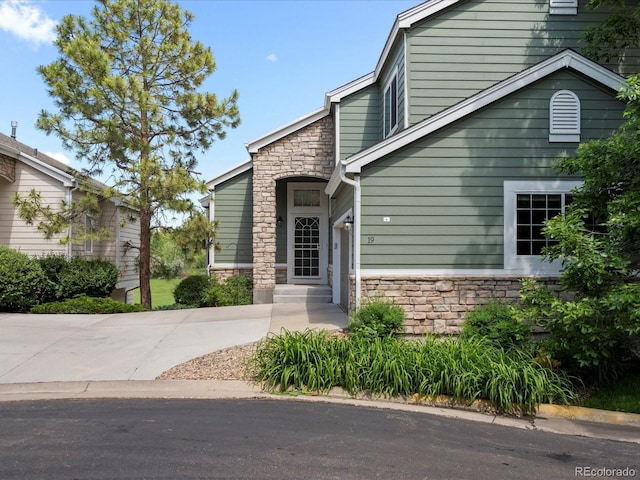7400 W Grant Ranch Blvd Unit 19, Littleton, CO 80123 - view of front of home with stone siding and driveway