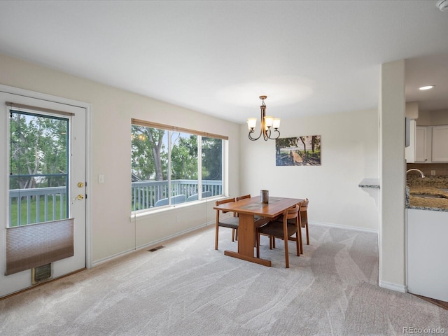 7400 W Grant Ranch Blvd Unit 19, Littleton, CO 80123 - dining space featuring a chandelier, light carpet, healthy amount of natural light, and baseboards