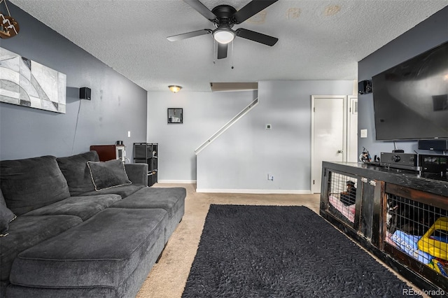 carpeted living room with a textured ceiling and ceiling fan