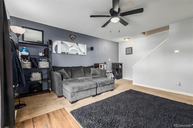 living room with carpet flooring, a textured ceiling, and ceiling fan