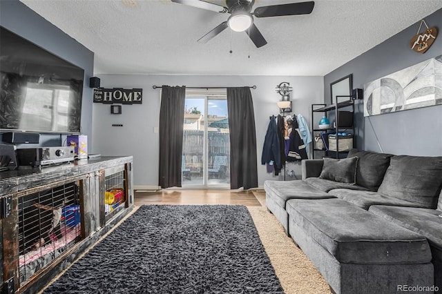 living room with hardwood / wood-style floors, a textured ceiling, and ceiling fan