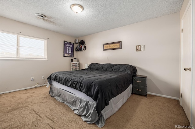 bedroom featuring carpet floors and a textured ceiling