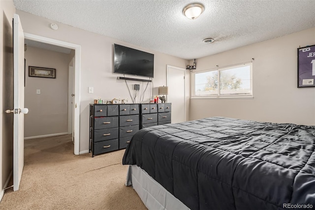 carpeted bedroom featuring a textured ceiling