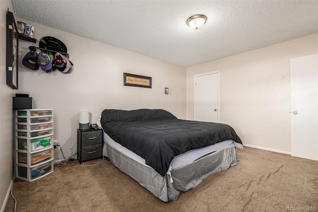 carpeted bedroom featuring a textured ceiling