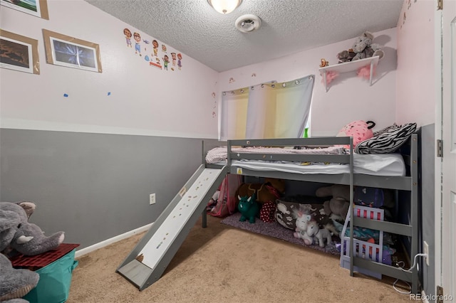 bedroom featuring light carpet and a textured ceiling