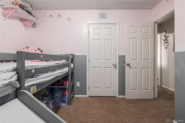 carpeted bedroom with a textured ceiling