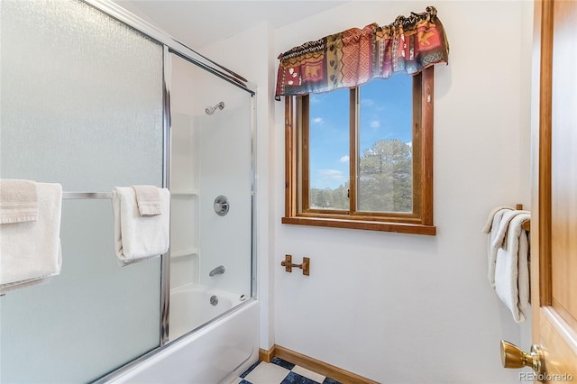 bathroom featuring bath / shower combo with glass door