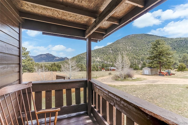 deck with a mountain view and a storage unit