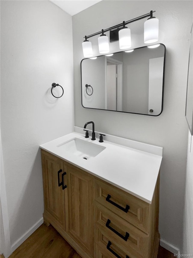 bathroom with vanity and hardwood / wood-style flooring