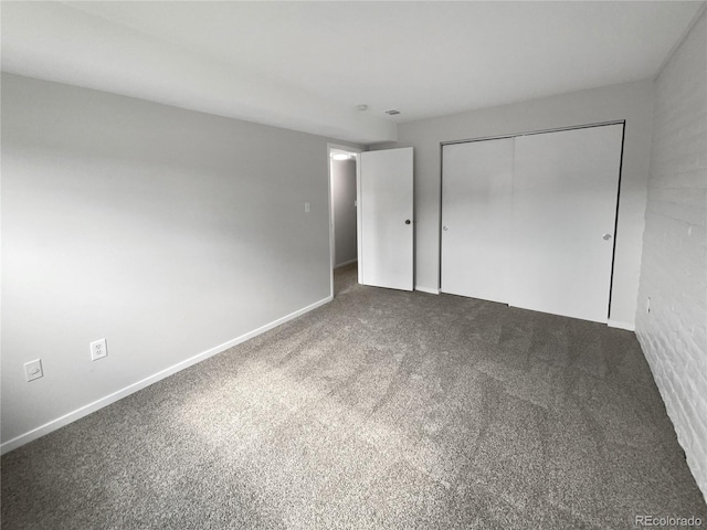 unfurnished bedroom with a closet and carpet