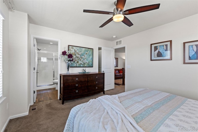 bedroom with carpet floors, connected bathroom, a ceiling fan, and baseboards
