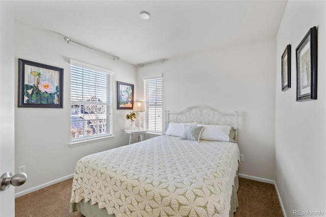 carpeted bedroom featuring baseboards