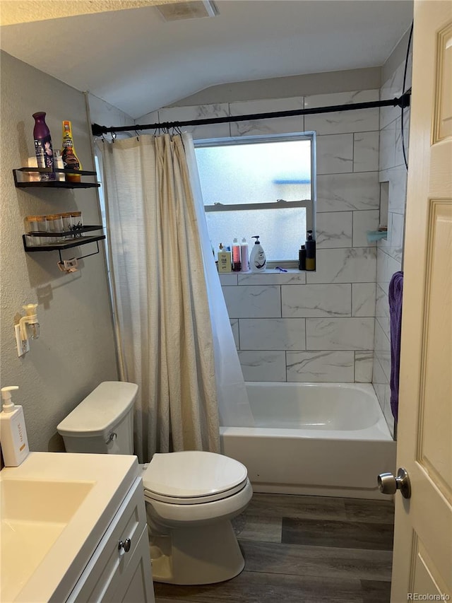 full bathroom featuring vanity, hardwood / wood-style floors, shower / bath combo with shower curtain, and toilet