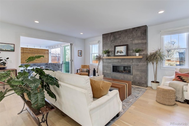 785 Delechant Dr, Erie, CO 80516 - living area with a tiled fireplace, wood finished floors, and recessed lighting