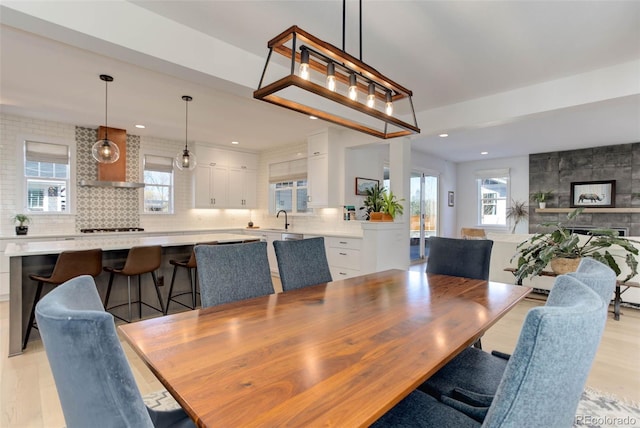 785 Delechant Dr, Erie, CO 80516 - dining room with a tile fireplace, light wood-type flooring, and recessed lighting