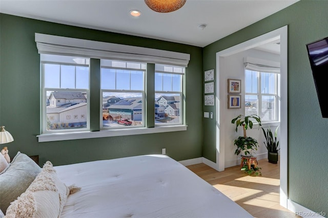 785 Delechant Dr, Erie, CO 80516 - bedroom featuring multiple windows, wood finished floors, and recessed lighting