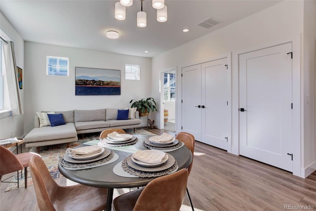785 Delechant Dr, Erie, CO 80516 - living room with plenty of natural light, light wood finished floors, a chandelier, and recessed lighting