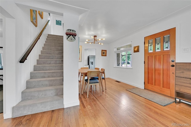 845 Jasmine St, Denver, CO 80220 - foyer featuring stairway, a chandelier, and light wood-style flooring