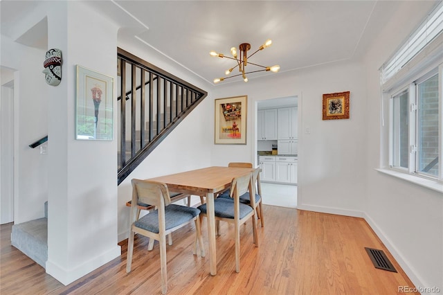 845 Jasmine St, Denver, CO 80220 - dining area with stairs, a chandelier, and light wood-style flooring