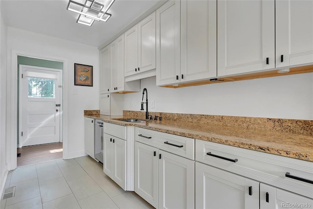 845 Jasmine St, Denver, CO 80220 - kitchen featuring white cabinets, light tile patterned floors, and light stone countertops
