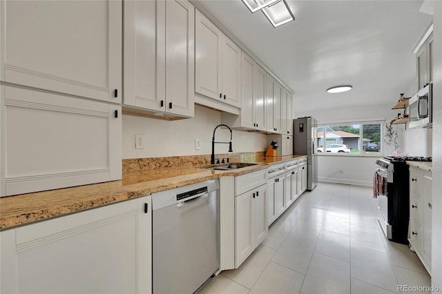 845 Jasmine St, Denver, CO 80220 - kitchen featuring range with gas stovetop, dishwashing machine, stainless steel microwave, white cabinetry, and light tile patterned floors