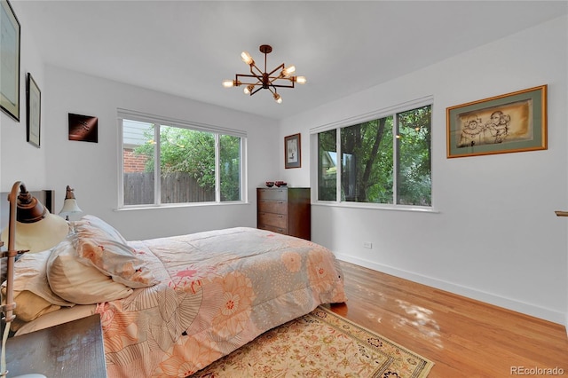 845 Jasmine St, Denver, CO 80220 - bedroom featuring a chandelier and wood finished floors