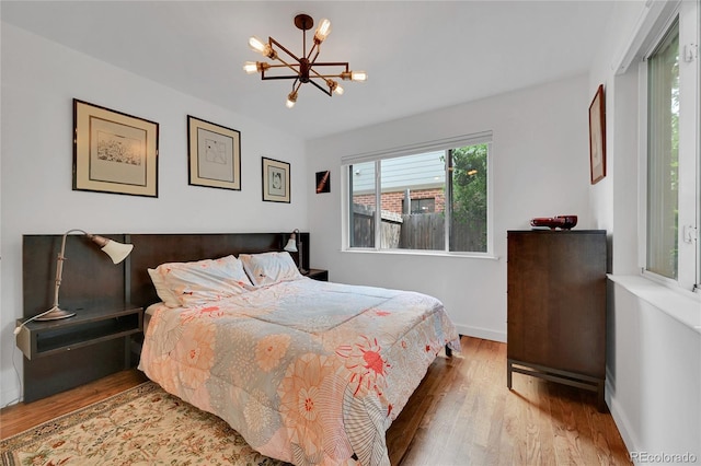 845 Jasmine St, Denver, CO 80220 - bedroom with wood finished floors and a chandelier