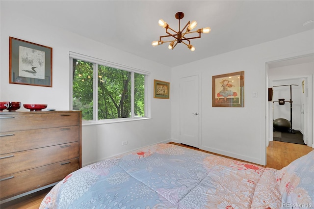 845 Jasmine St, Denver, CO 80220 - bedroom with a chandelier and light wood-style floors
