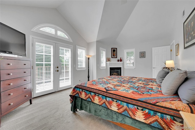 845 Jasmine St, Denver, CO 80220 - bedroom with french doors, access to outside, lofted ceiling, light carpet, and a glass covered fireplace