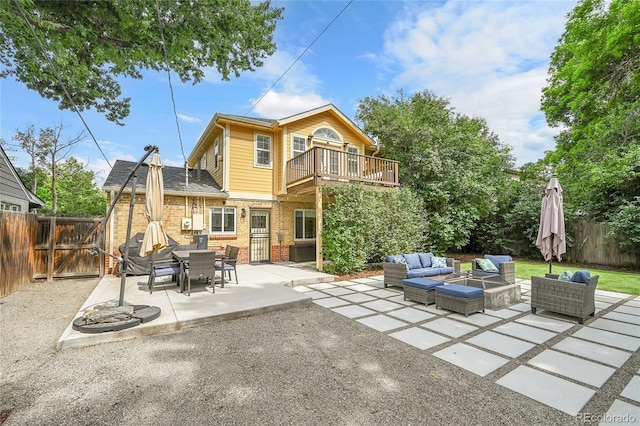 845 Jasmine St, Denver, CO 80220 - back of house featuring an outdoor living space, a fenced backyard, a patio, brick siding, and a balcony