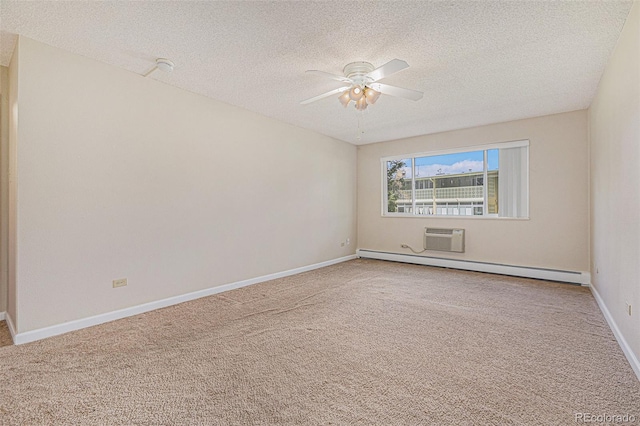 empty room with carpet, an AC wall unit, a textured ceiling, and a baseboard heating unit