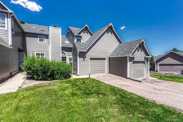 2028 Palm Dr, Colorado Springs, CO 80918 - view of front facade with roof with shingles, a front yard, an attached garage, and a chimney