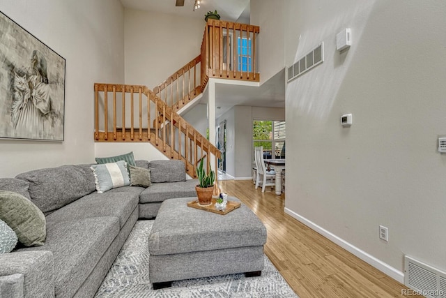 2028 Palm Dr, Colorado Springs, CO 80918 - living area with wood finished floors, a high ceiling, stairway, and a ceiling fan