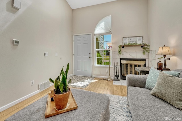 2028 Palm Dr, Colorado Springs, CO 80918 - living room with wood finished floors, a tile fireplace, and a towering ceiling