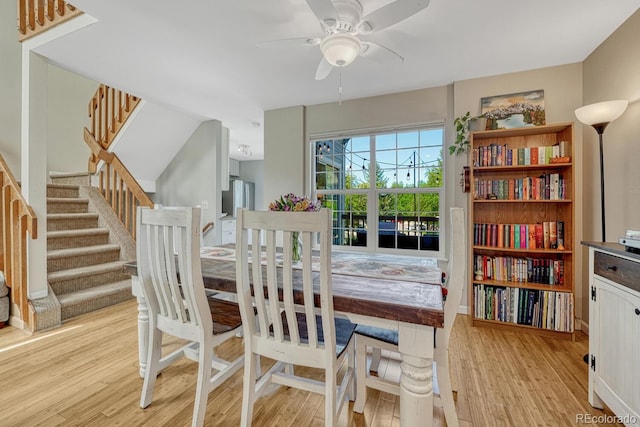 2028 Palm Dr, Colorado Springs, CO 80918 - dining space featuring light wood-style floors, ceiling fan, and stairway