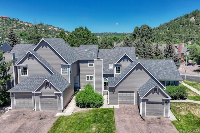 2028 Palm Dr, Colorado Springs, CO 80918 - view of front of property featuring a garage, driveway, roof with shingles, and a front yard