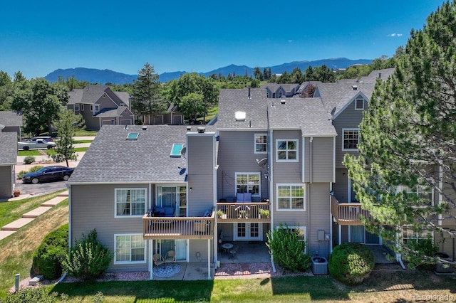 2028 Palm Dr, Colorado Springs, CO 80918 - rear view of house with a patio area, a residential view, and a deck with mountain view