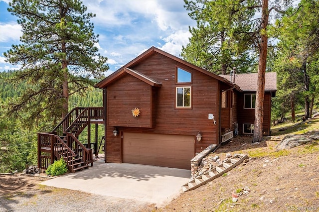 84 Sunny Ridge Ln, Bailey, CO 80421 - rustic home featuring driveway, an attached garage, stairway, and roof with shingles