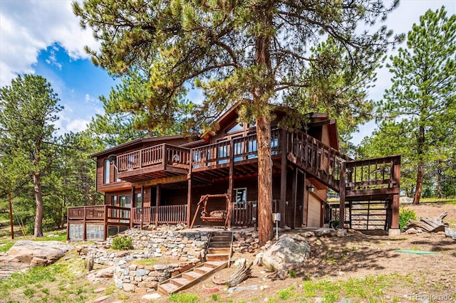 84 Sunny Ridge Ln, Bailey, CO 80421 - rear view of house with stairs, a wooden deck, and a garage