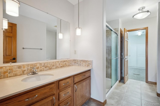 84 Sunny Ridge Ln, Bailey, CO 80421 - bathroom featuring a shower stall, vanity, tasteful backsplash, and tile patterned floors
