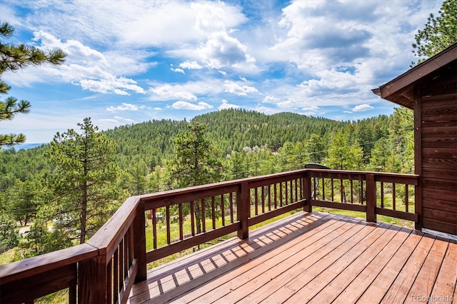 84 Sunny Ridge Ln, Bailey, CO 80421 - wooden terrace featuring a wooded view