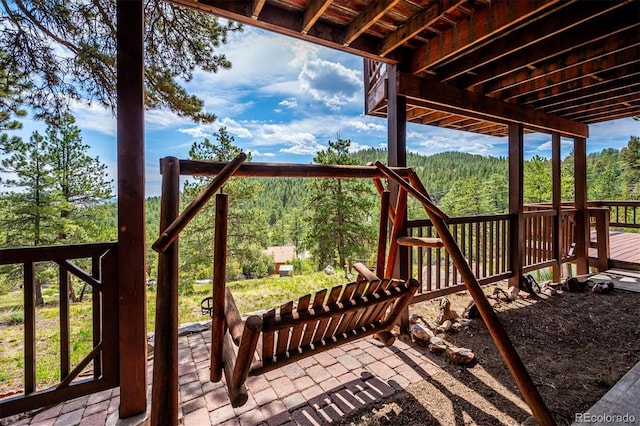 84 Sunny Ridge Ln, Bailey, CO 80421 - wooden terrace with a view of trees